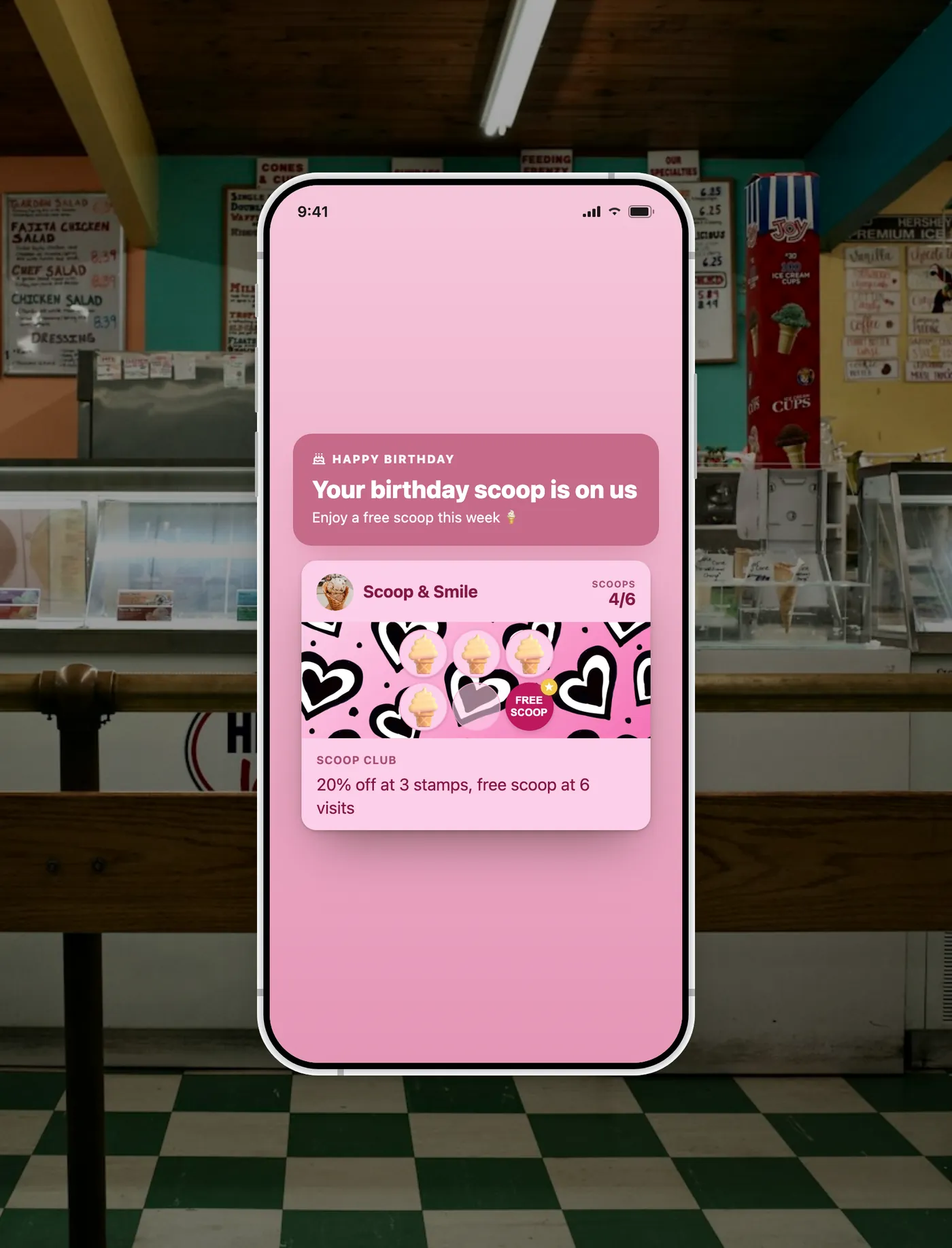 A FaveCard loyalty card on a phone at an ice cream shop showing an automated Happy Birthday free scoop offer.